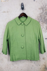 Women's vintage 1960's cropped style green cotton material button up lightweight jacket with 3/4 arm length.