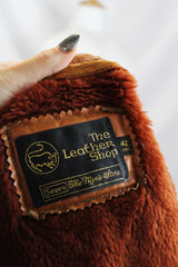 Men's or women's vintage 1970's The Leather Shop, Sears The Men's Store label long sleeve short length camel brown colored leather zip up jacket.