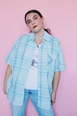 Men's vintage 1980's Levi's label short sleeve button up shirt in plaid print. Blue, white, yellow, green, and burnt orange. Lightweight Cotton materials.