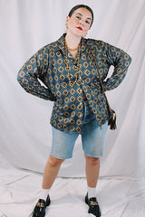 Men's or women's vintage 1970's JCPenney label long sleeve button up shirt with dagger collar in a polyester material. Brown color with all over blue print.
