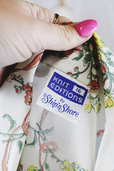 Women's vintage 1970's Knit Editions by Ship 'n Shore long sleeve button up blouse with a dagger collar in an all over white and blue stripes pattern and floral print.