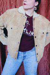 Women's or men's vintage 1950's Alaska Sleeping Bag Co., Portland, Oregon label long sleeve tan colored suede jacket with popper buttons and cream shearling liner.