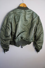 Men's or women's army zip up bomber jacket with long sleeves. Army green color with orange satin liner. Reversible.
