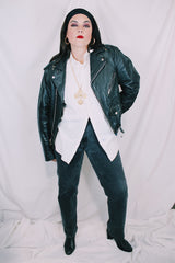 Men's or women's vintage 1980's long sleeve black leather motorcycle jacket with silver hardware. Zipper front closure and pockets.