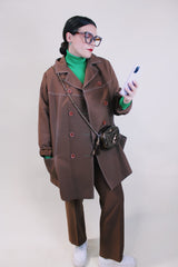 Women's vintage 1970's lightweight brown colored pea coat with a double breasted closure. Brown buttons and white contrast stitching