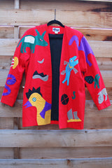 Women's vintage 1980's Mr. Girasol, Made in Mexico label long sleeve open front lightweight jacket in red with all over multicolored animals.