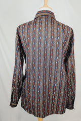 Men's or women's vintage 1970's Montgomery Ward, JCPenney label long sleeve button up shirt in lightweight polyester material. Black with tan and orange vertical stripe pattern.