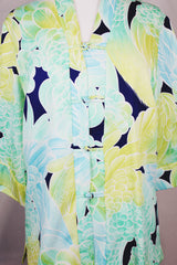 Women's vintage 1970's long sleeve button up tunic blouse with all over green and navy floral print. Flared sleeved and fabric covered buttons.