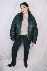 Men's vintage unknown, maybe around 40's-50's long sleeve black distressed leather jacket with zipper front closure and buckles on cuffs.