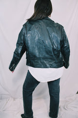 Men's or women's vintage 1980's long sleeve black leather motorcycle jacket with silver hardware. Zipper front closure and pockets.