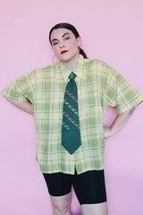 Men's or women's vintage 1960's Cortland short sleeve button up collared shirt with two chest pockets in a green and yellow plaid print.