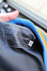 Men's or women's vintage 1994 Settlemien's, Portland, Oregon label long sleeve baby blue and cream varsity letterman jacket with yellow trim in leather and wool material.