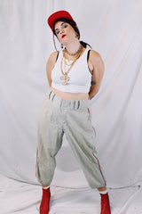Men's vintage 1940's Rawlings, St. Louis label capri length baseball pants in grey wool material with red stripe piping along each side of leg.