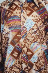 Men's vintage 1970's EPI, European Prime International label long sleeve lightweight polyester button up shirt in brown with all over multicolored abstract print.