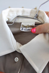 Women's vintage 1970's King Louie Creation, Made in USA label short sleeve polyester material polo top in light beige with cream and orange trim.