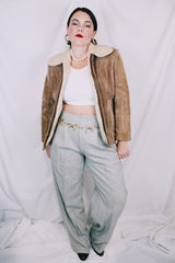 Men's or women's vintage 1970's light tan brown suede leather jacket with cream soft shearling liner. Zipper front closure and side pockets.