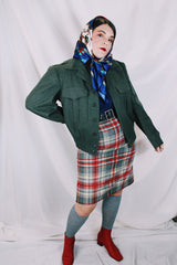 Women's or men's vintage cropped army jacket in a dark green grey wool material. Has a button closure and two front chest pockets.