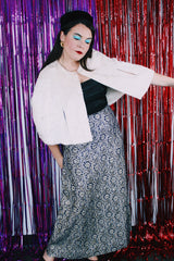 Women's vintage 1970's maxi length navy blue skirt. Skirt has an all over silver and gold embroidered metallic pattern.