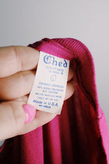 Women's or men's vintage 1980's Ched, Quality Knits by Anvil, Made in USA label magenta pink short sleeve tee with white graphic on front and on sleeve in a polyester and cotton material.