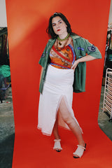 Women's vintage 1970's Sirena label sleeveless one piece swimsuit with all over orange, red, and purple print.