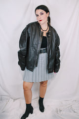 Men's or women's vintage 1980's Kirk's Suede Life label long sleeve oversized dark chocolate brown leather bomber jacket with zipper front closure.