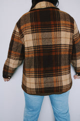 Women's vintage 1970's Woolrich, Made in USA label long sleeve zip up plaid shacket in a wool blend material. All over brown plaid print. Has pockets and faux fur liner.