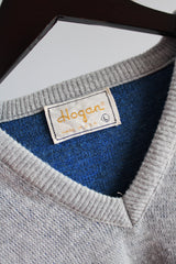 Women's or men's vintage 1980's Hogan label long sleeve blue argyle printed pullover sweater with a V shaped neckline in a soft acrylic material.