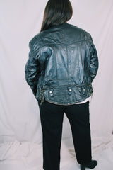 Men's or women's vintage 1970's Genuine Leather, Made in Mexico label long sleeve black leather moto leather jacket with silver hardware.