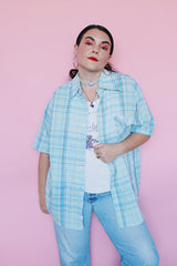 Men's vintage 1980's Levi's label short sleeve button up shirt in plaid print. Blue, white, yellow, green, and burnt orange. Lightweight Cotton materials.