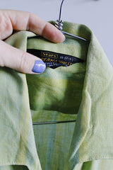 Men's vintage 1960's Sears label short sleeve button up shirt with collar and one left chest pocket in a lime green striped cotton material.