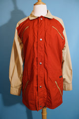 Women's or men's vintage 1980's Aspen label long sleeve zip up lightweight windbreaker jacket in tan and burn orange.