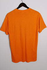 Women's or men's vintage 1980's Hanes, Fifty-Fifty, Made in USA label short sleeve orange tee with graphic on the front in black and white in a Polyester and cotton material.