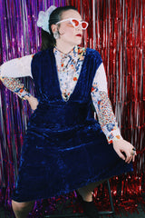 Women's vintage 1970's sleeveless dark blue crushed velvet knee length dress. Has a deep V shaped neckline in the front.