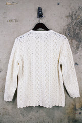 Women's vintage 1970's long sleeve cream colored button up acrylic sweater with scalloped edges on hem and cuffs.