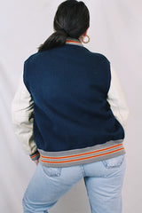 Men's vintage 1960's Skookum Letterman, Centralia Knitting Mills, Centralia Washington label long sleeve navy, white, and orange varsity letterman jacket in wool and leather material.