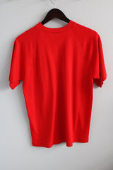 Men's or women's vintage 1980's short sleeve bright red t-shirt with one left chest pocket and a ribbed collar.
