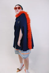 Women's vintage 1960's navy blue wool material poncho with slits for arms, gold hardware and gold buttons. Fully lined.