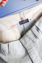 Men's vintage 1940's Rawlings, St. Louis label capri length baseball pants in grey wool material with red stripe piping along each side of leg.