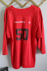 Women's or men's vintage 1970's Southern Athletic label long sleeve red cotton and nylon blend material sport jersey with v shaped neckline and wording on front and back.