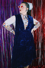 Women's vintage 1970's sleeveless dark blue crushed velvet knee length dress. Has a deep V shaped neckline in the front.