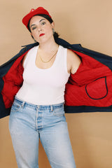 Men's or women's vintage 1970's Unitog Company, Union Made in USA label size large long sleeve navy blue station jacket that zips up the front with red nylon liner.