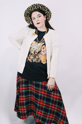 Women's vintage 1970's long sleeve cream colored button up acrylic sweater with scalloped edges on hem and cuffs.