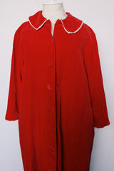 Women's vintage 1960's long length long sleeved red velvet robe duster with a peter pan collar and pink stain trim. Buttons up the front.
