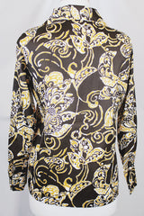 Women's vintage 1970's long sleeve button up blouse with a dagger collar in chocolate brown and tan colored all over abstract print.