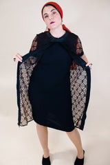 Women's vintage 1960's short sleeve mini length black dress with lace overlay and ribbon trim and bow. Zipper in the back.