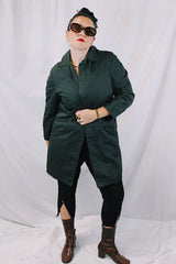 Men's or women's vintage 1960's Brent Prep Sold Exclusively by Montgomery Ward long sleeve long length cotton material lightweight trench coat in a dark green and all over subtle plaid print.