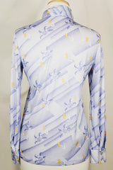 Women's vintage 1970's Devon long sleeve button up blouse with a dagger collar. Light purple color with all over ditsy floral print.