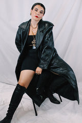 Men's or women's vintage 1980's Vakko Sport, Made in USA label long sleeve long length black leather trench coat. Double breasted closure, shoulder pads, and matching tie belt.