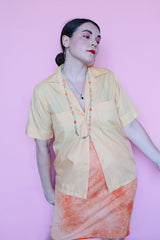 Men's or women's vintage 1960's Crystalaire, A Kentfield Exclusives short sleeve light orange colored button up shirt with two chest pockets.