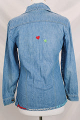 Women's vintage 1970's Montgomery Ward label long sleeve medium wash denim chambray top with snapper buttons.